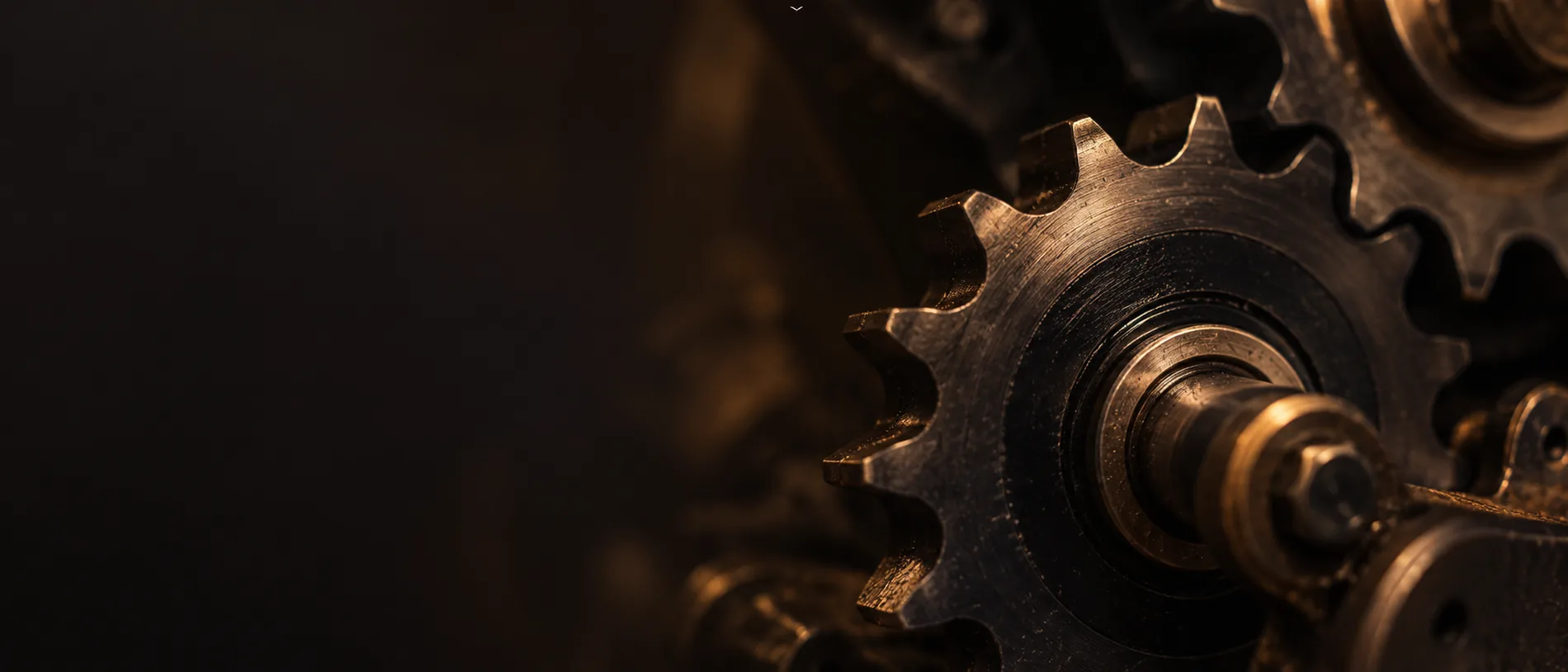 Brass gears meshing in low light